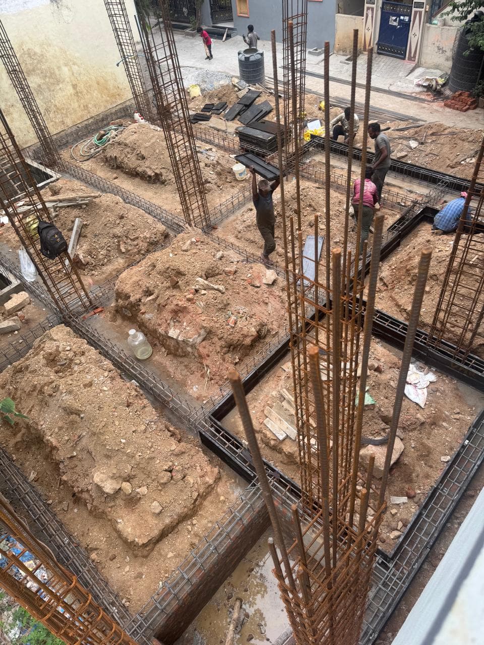 Foundation footings — column starter rebar with site team in frame