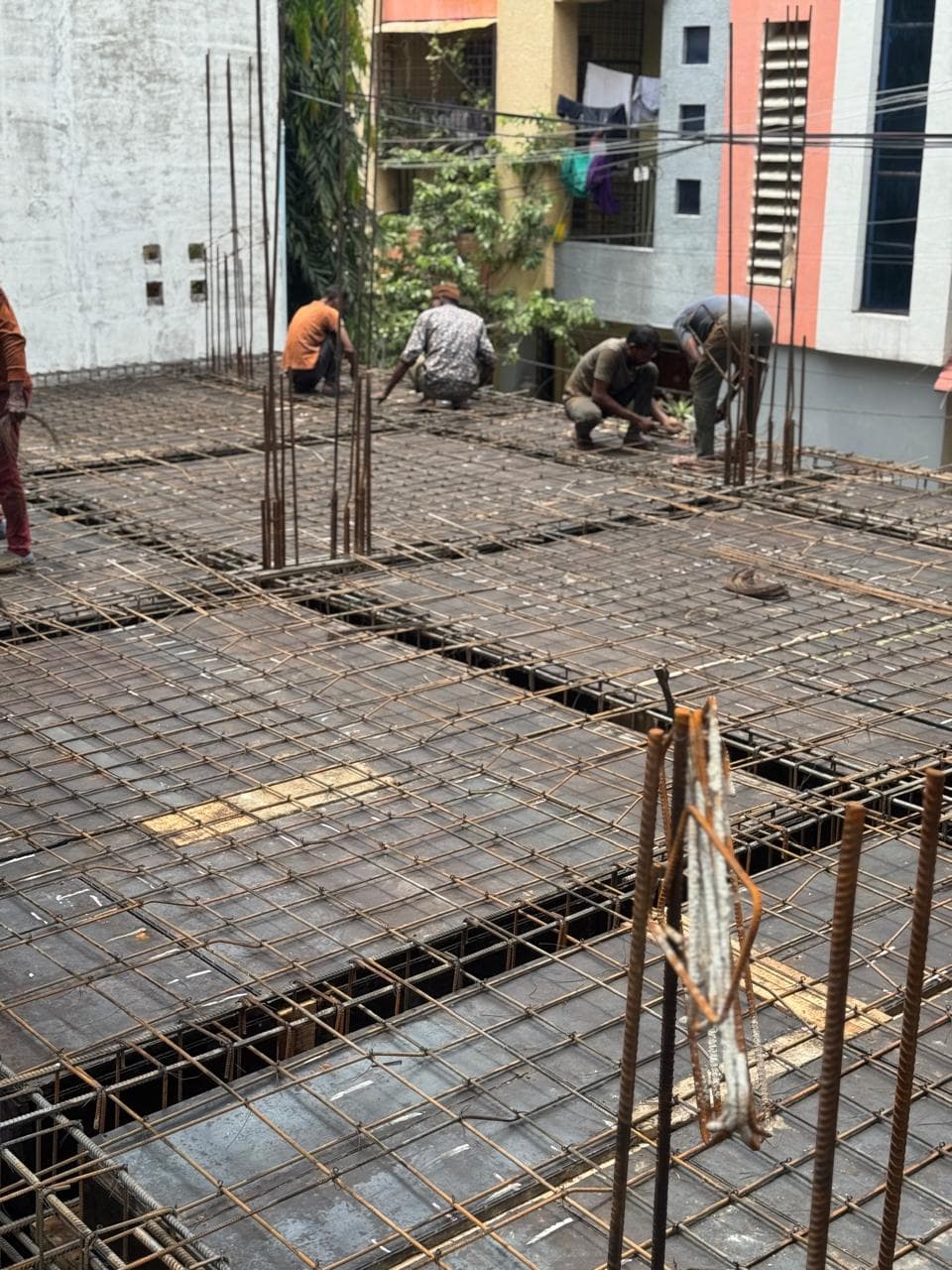 Site team binding the first slab rebar grid